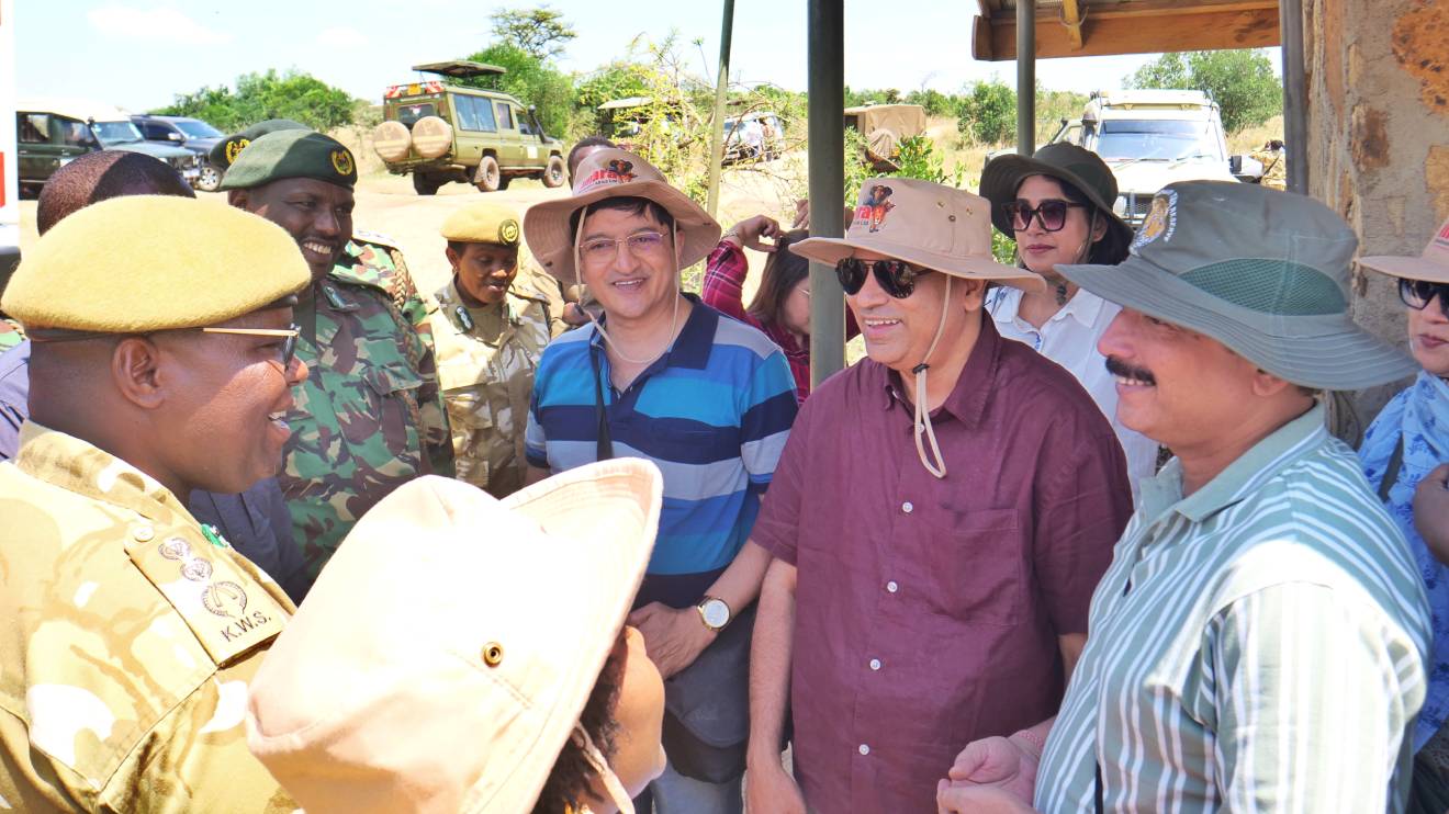 KTB CEO June Chepkemei (partly hidden in a cap) and the Kenya Widlife Service (KWS) Director General Dr. Erustus Kanga (L) interact with visitors at the Maasai Mara National Reserve. PHOTO/COURTESY